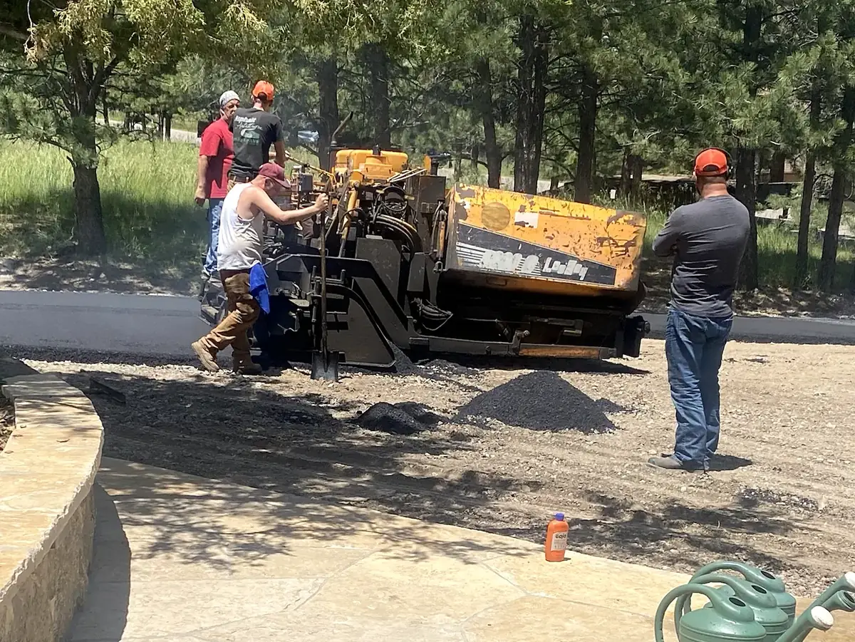 Paving crew laying asphalt with a paver on a prepared base, Salida, Colorado