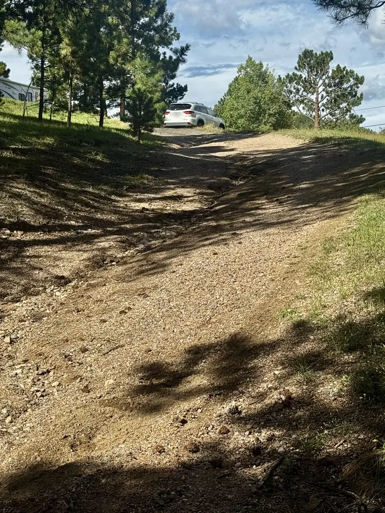 Before: washed-out gravel driveway in Evergreen, Colorado, seen from the bottom looking uphill